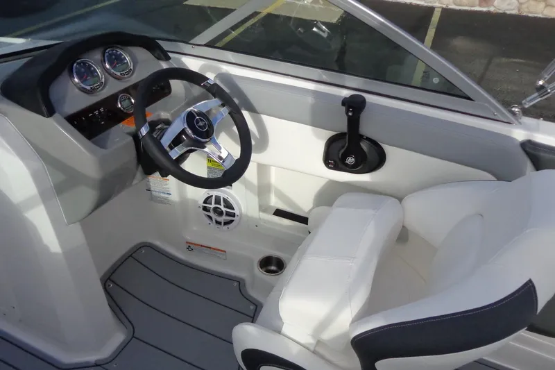 Slide: The Image of 2024 Chaparral 19 SSi OB boat cockpit with steering wheel and controls. - 8