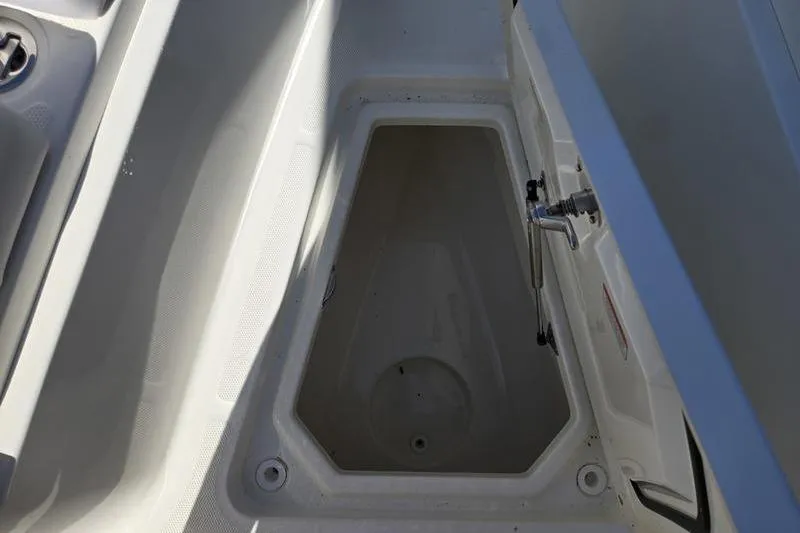 Slide: The Image of Open storage compartment on a 2021 Mako 236 CC boat. - 10