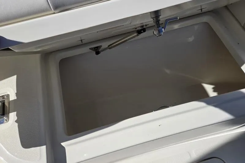 Slide: The Image of Open storage compartment on 2021 Mako 236 CC boat, showcasing interior space. - 11