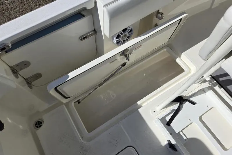 Slide: The Image of 2021 Mako 236 CC boat interior storage compartment with open hatch. - 20
