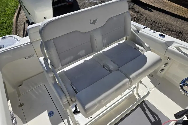 Slide: The Image of 2021 Mako 236 CC boat with cushioned seating and sleek design. - 22