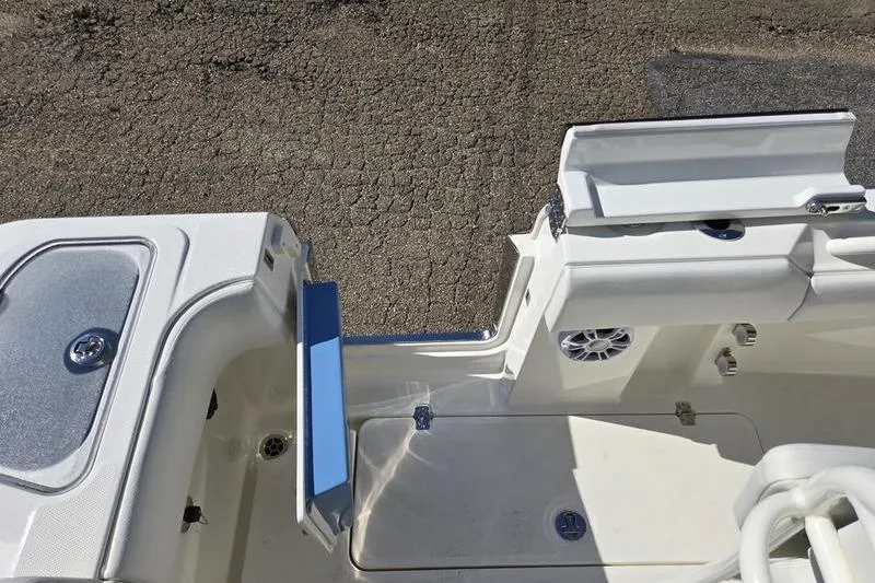 Slide: The Image of 2021 Mako 236 CC boat interior with storage compartments and speaker. - 24
