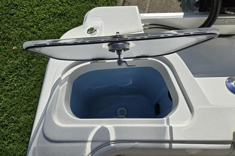 Slide: The Image of Open compartment on 2021 Mako 236 CC boat, showcasing storage space. - 25