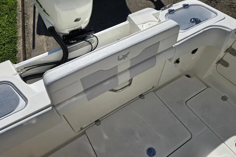 Slide: The Image of 2021 Mako 236 CC boat interior with seating and storage compartments. - 29