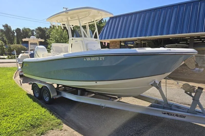 Slide: The Image of 2021 Mako 236 CC boat on trailer outside a marine shop. - 3