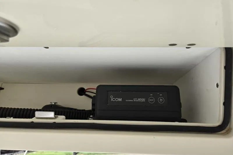 Slide: The Image of ICOM radio equipment inside a 2021 Mako 236 CC boat compartment. - 5