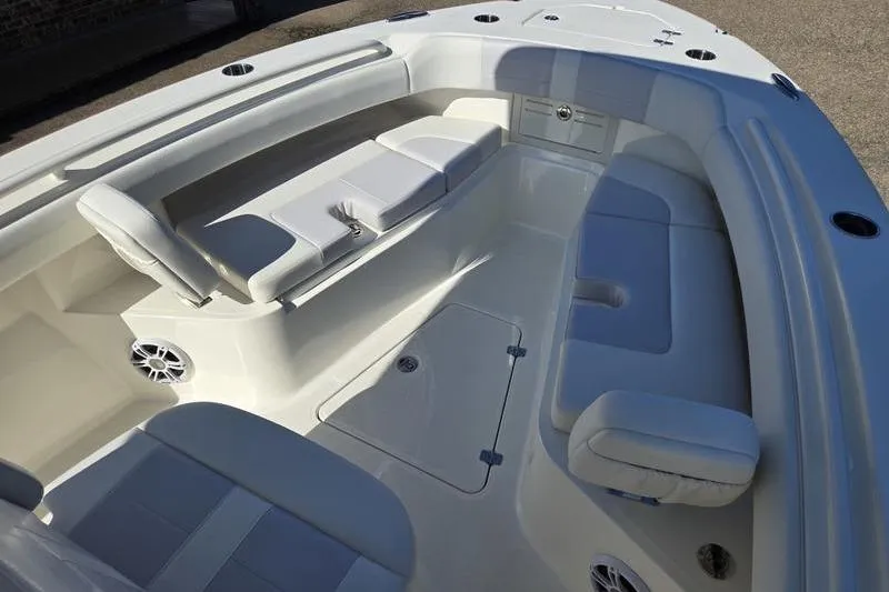 Slide: The Image of 2021 Mako 236 CC boat interior with cushioned seating and storage compartments. - 6