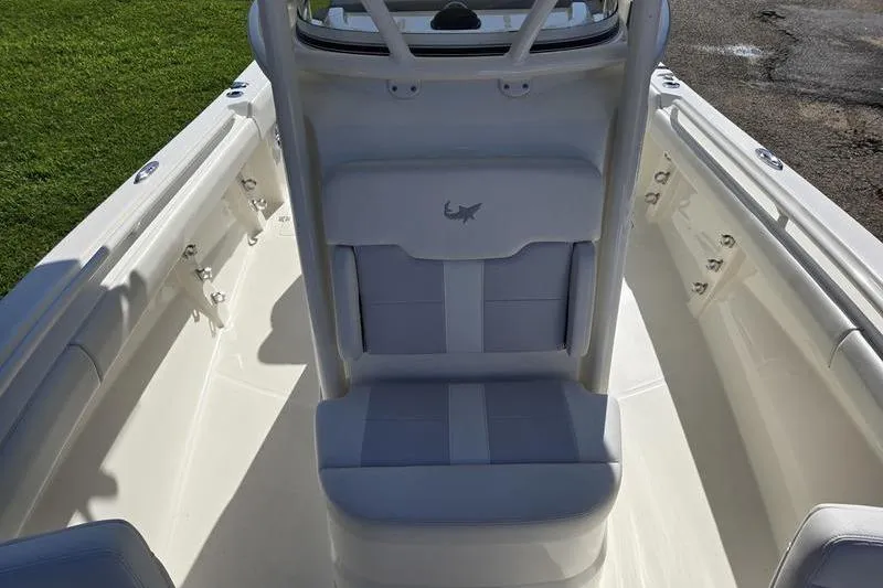 Slide: The Image of 2021 Mako 236 CC boat interior with cushioned seating and sleek design. - 7