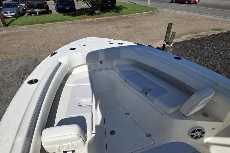Slide: The Image of 2021 Mako 236 CC boat interior with white seating and storage compartments. - 8