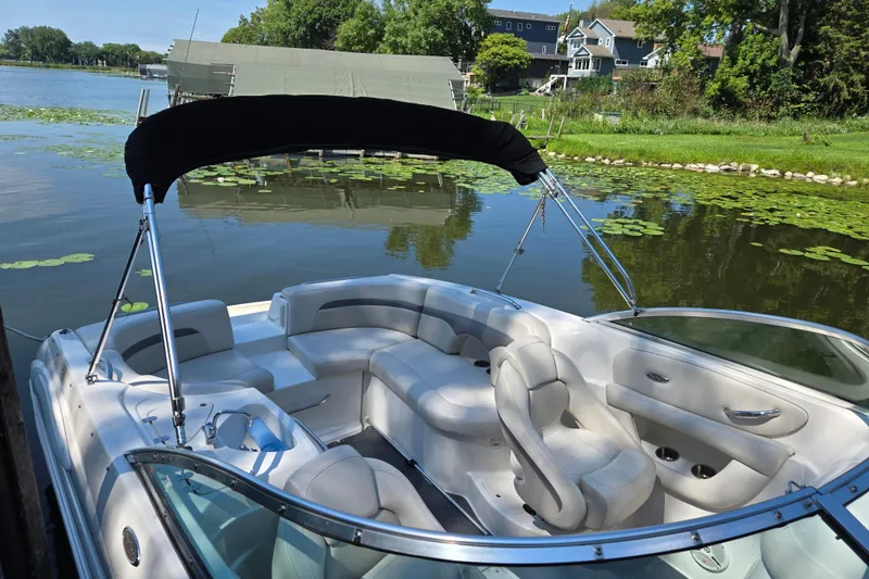 Slide: The Image of 2005 Chaparral 260 SSi boat with canopy on a serene lake. - 1