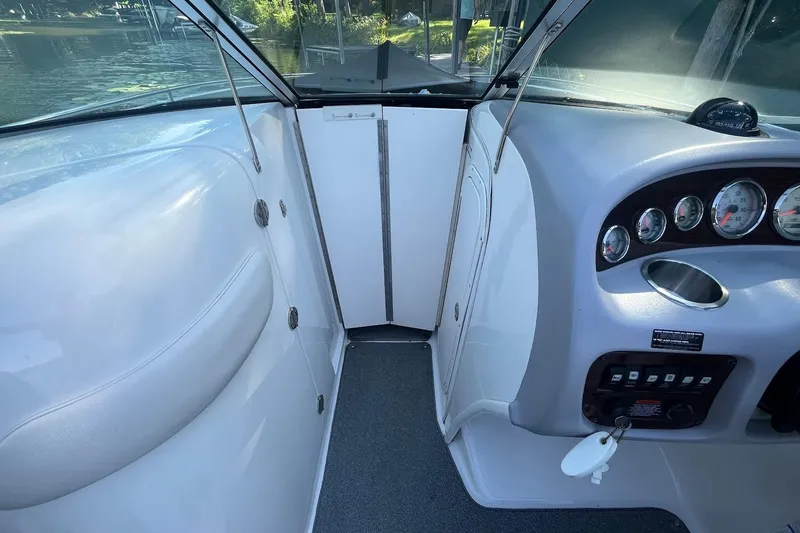 Slide: The Image of 2005 Chaparral 260 SSi boat interior with dashboard and seating area. - 11