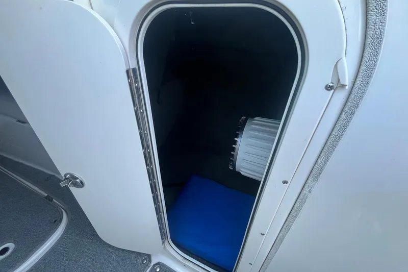 Slide: The Image of Open storage compartment on 2005 Chaparral 260 SSi boat, showing interior details. - 12