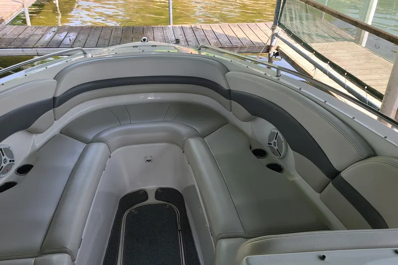 Slide: The Image of 2005 Chaparral 260 SSi boat interior with gray seating and cup holders. - 16