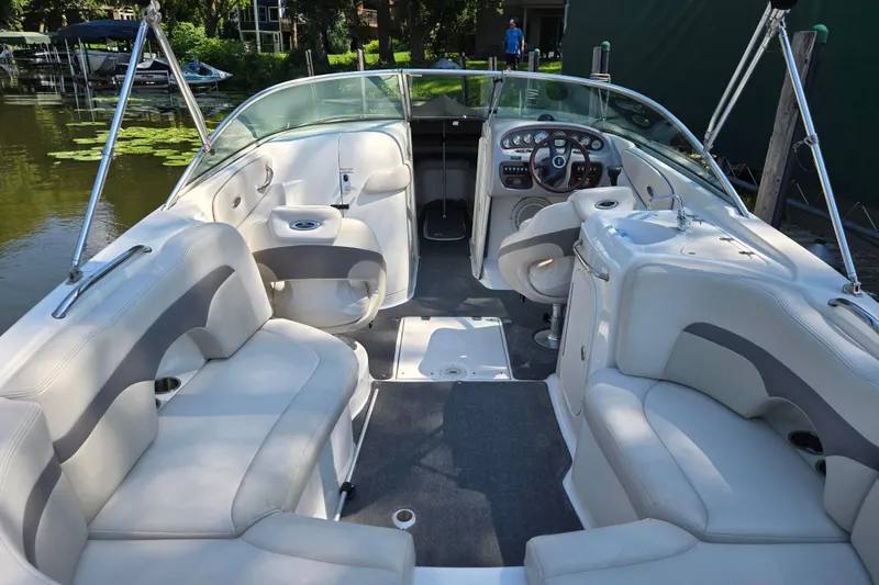 Slide: The Image of 2005 Chaparral 260 SSi boat interior with white seating and steering console. - 3