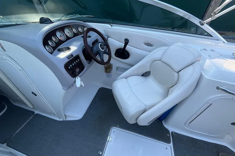Slide: The Image of 2005 Chaparral 260 SSi boat interior with steering wheel and white captain's chair. - 4