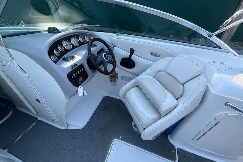 Slide: The Image of 2005 Chaparral 260 SSi boat interior with steering wheel and white captain's seat. - 5