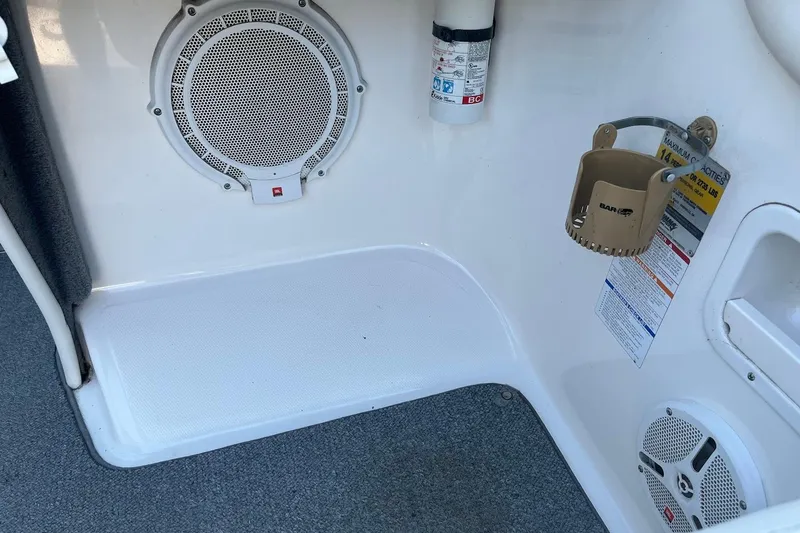 Slide: The Image of 2005 Chaparral 260 SSi boat interior with speaker, fire extinguisher, and cup holder. - 9