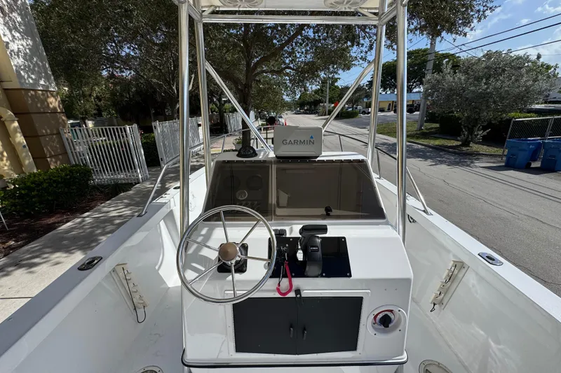 Slide: The Image of 1988 Pursuit C 200 Center Console boat with Garmin navigation system, docked outdoors. - 7