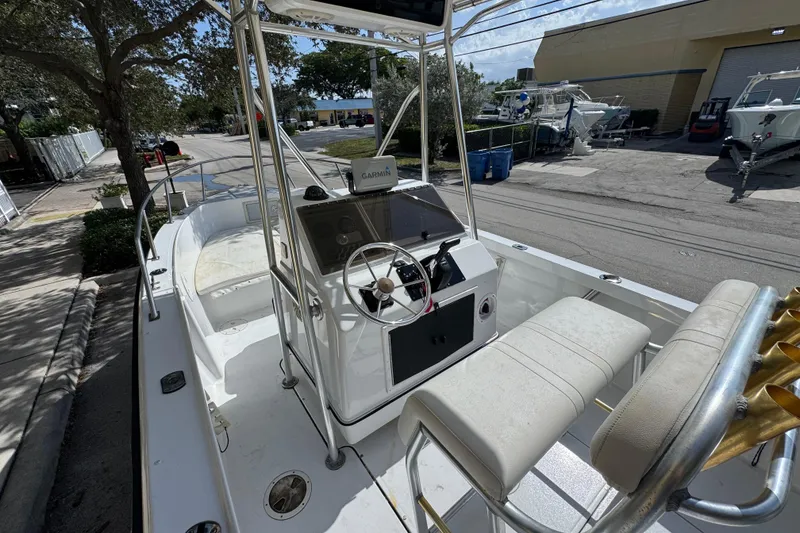 Slide: The Image of 1988 Pursuit C 200 Center Console boat with Garmin navigation, parked outdoors. - 9