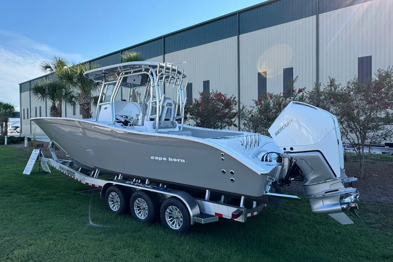 Slide: The Image of 2026 Cape Horn 31 T boat with dual outboard engines, displayed outdoors. - 4