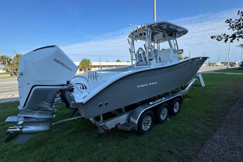 Slide: The Image of 2026 Cape Horn 31 T boat with Mercury engine, docked outdoors. - 8