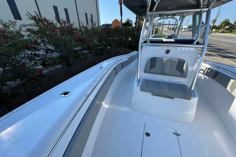 Slide: The Image of 2026 Cape Horn 31 T boat interior with T-top and Garmin electronics, under clear blue sky. - 26
