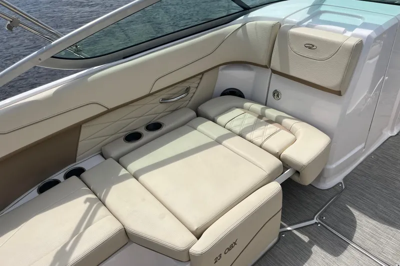 Slide: The Image of 2019 Regal 23 OBX boat interior with beige seating and cup holders. - 11