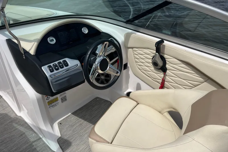 Slide: The Image of Luxurious seating on 2019 Regal 23 OBX boat with beige upholstery and cup holders. - 12