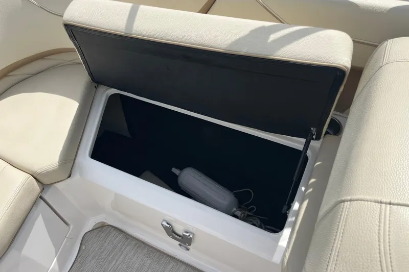 Slide: The Image of 2019 Regal 23 OBX boat interior with storage compartment and speaker. - 16