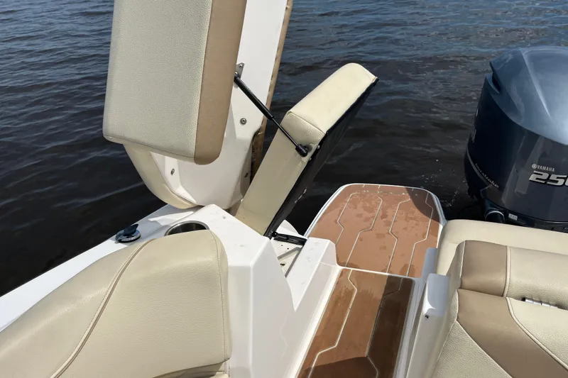 Slide: The Image of Open storage compartment in 2019 Regal 23 OBX boat with beige seating. - 17