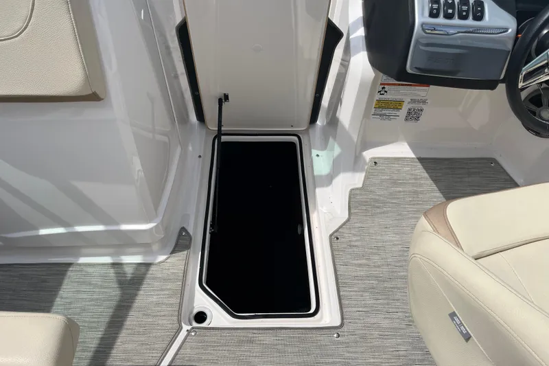Slide: The Image of 2019 Regal 23 OBX boat interior storage compartment with beige seating. - 19