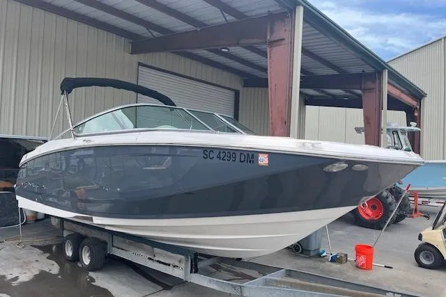 Slide: The Image of 2019 Regal 23 OBX boat cruising on a sunny lake. - 2