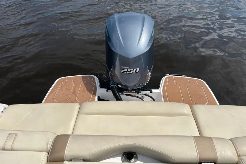 Slide: The Image of 2019 Regal 23 OBX boat interior with open storage compartment and beige seating. - 20