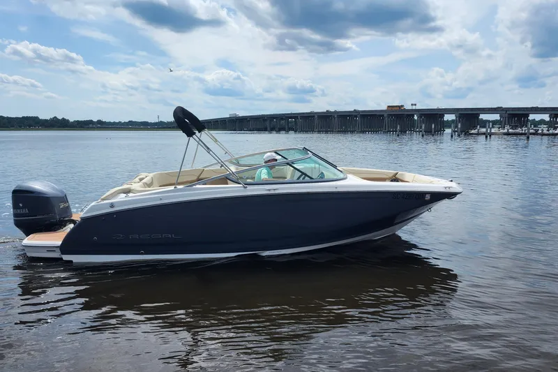 Slide: The Image of 2019 Regal 23 OBX boat with Yamaha 250 engine, featuring beige seating and teak-style decking. - 22