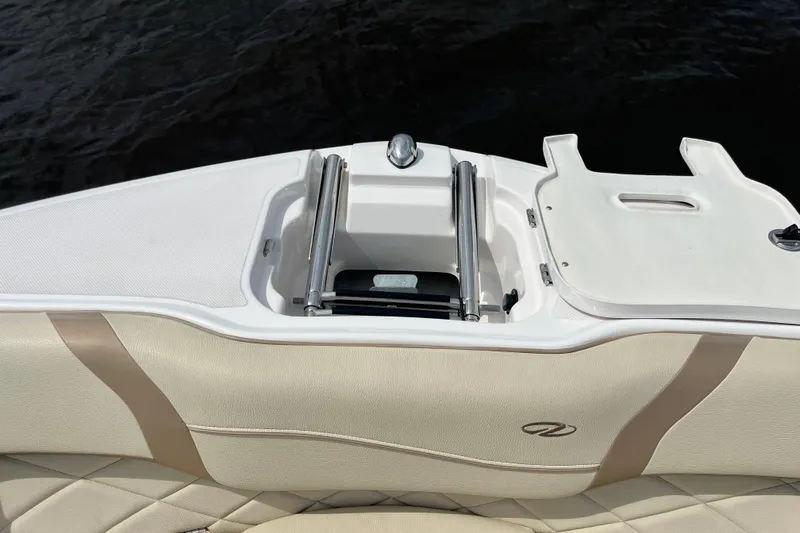 Slide: The Image of 2019 Regal 23 OBX boat interior with beige seating and water view. - 7