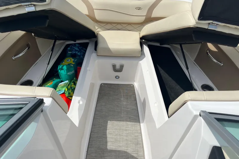 Slide: The Image of 2019 Regal 23 OBX boat interior with beige seating and storage compartment. - 8