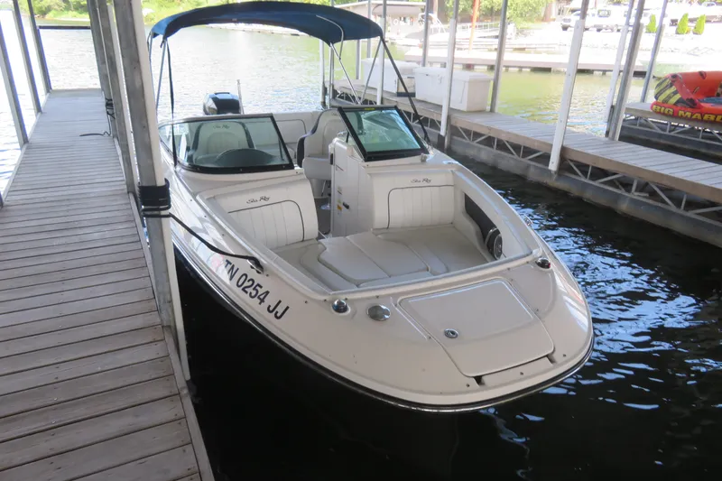 Slide: The Image of 2014 Sea Ray 220 Sundeck Outboard boat docked in a marina. - 3