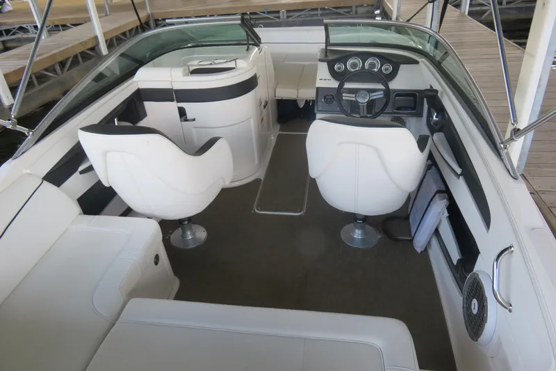 Slide: The Image of 2014 Sea Ray 220 Sundeck Outboard interior with white seating and dashboard. - 4