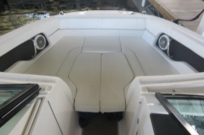 Slide: The Image of 2014 Sea Ray 220 Sundeck Outboard interior with spacious seating and speakers. - 7