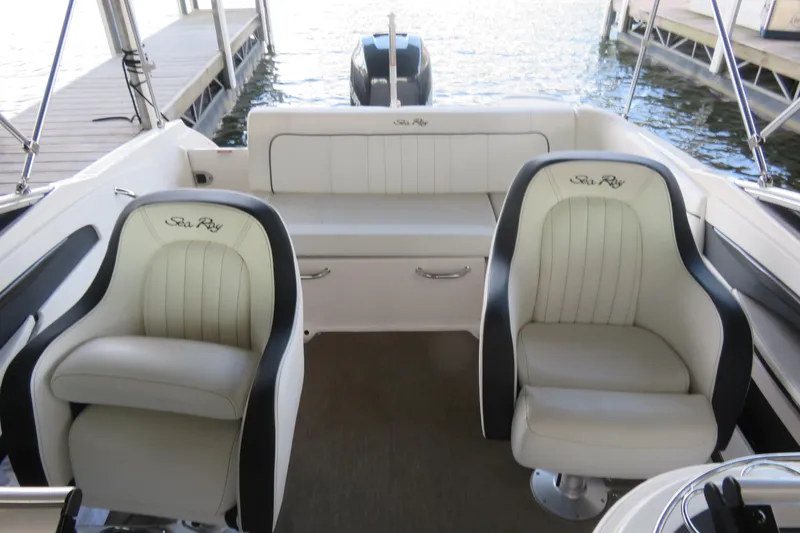 Slide: The Image of 2014 Sea Ray 220 Sundeck Outboard interior with plush seating and water view. - 8