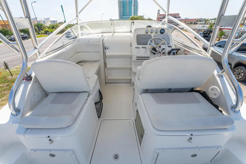 Slide: The Image of 2010 Triton 301XD boat interior with seating and storage compartments. - 14