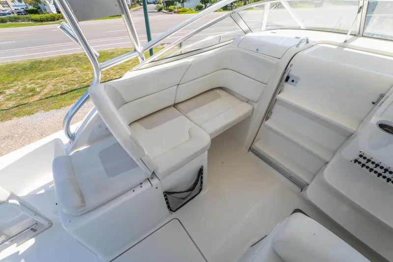 Slide: The Image of 2010 Triton 301XD boat cockpit with steering wheel, gauges, and seating. - 16