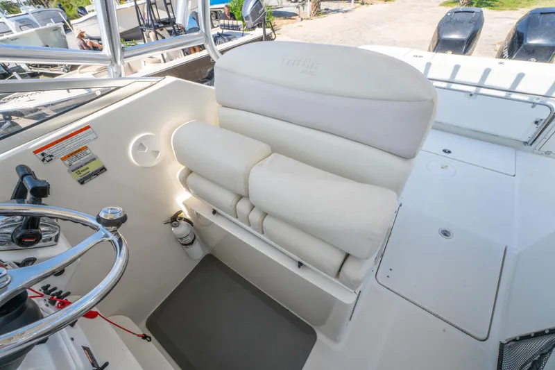 Slide: The Image of 2010 Triton 301XD boat helm with Garmin displays and steering wheel. - 18