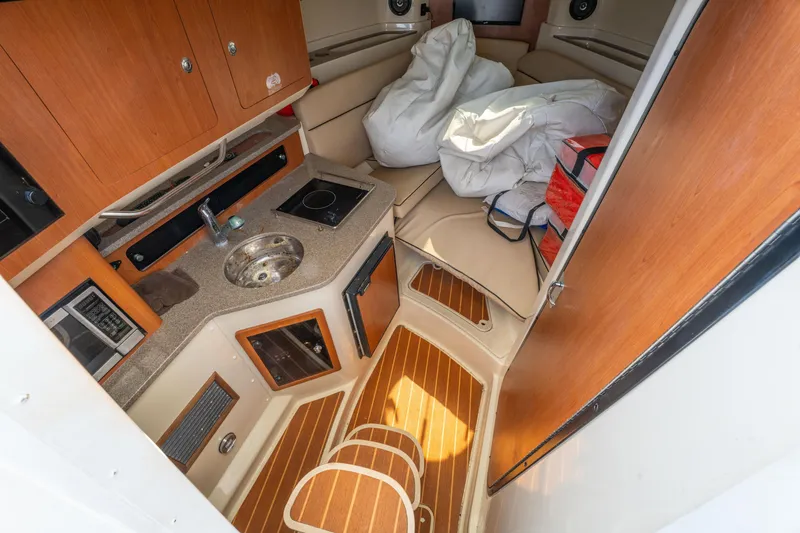 Slide: The Image of Interior view of a 2010 Triton 301XD boat cabin with Garmin equipment. - 21