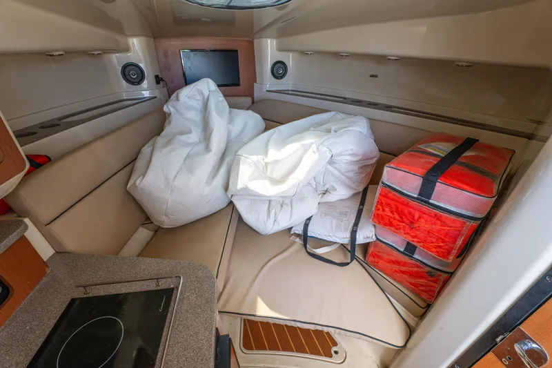 Slide: The Image of Interior of 2010 Triton 301XD boat with kitchenette and seating area. - 22