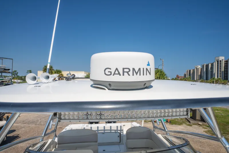 Slide: The Image of Compact kitchen area in a 2010 Triton 301XD boat with sink and stove. - 27