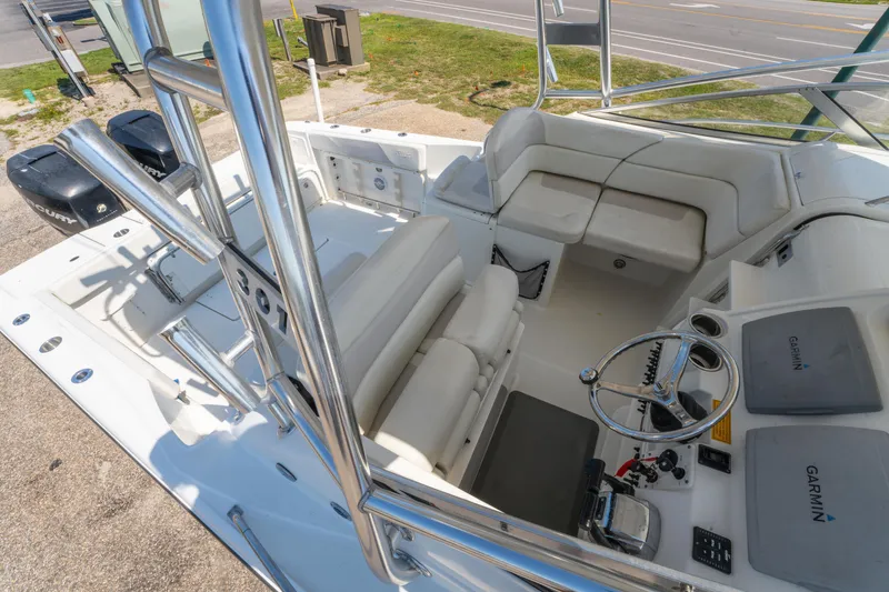 Slide: The Image of Triton 301XD 2010 boat interior with seating, steering wheel, and Garmin equipment. - 31
