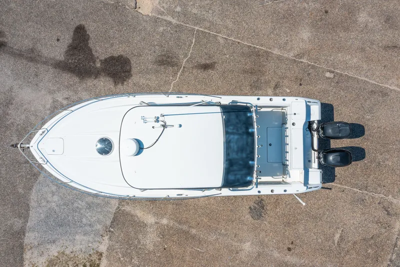 Slide: The Image of Overhead view of 2010 Triton 301XD boat on concrete surface. - 32