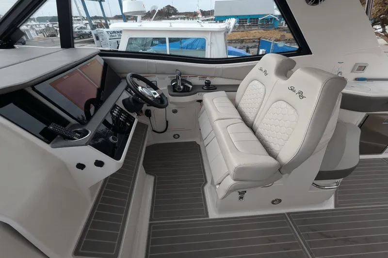 Slide: The Image of 2023 Sea Ray Sundancer 320 Outboard helm with dual seats and modern controls. - 13