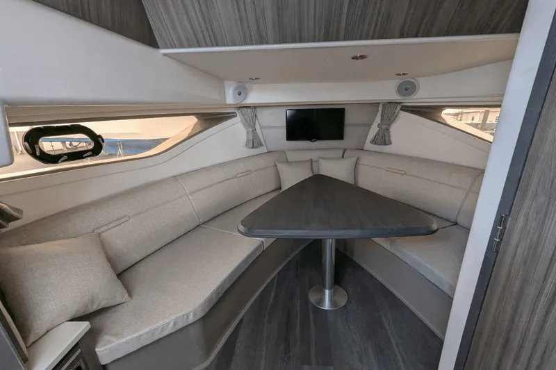 Slide: The Image of Luxurious interior of 2023 Sea Ray Sundancer 320 Outboard with elegant seating and table. - 15